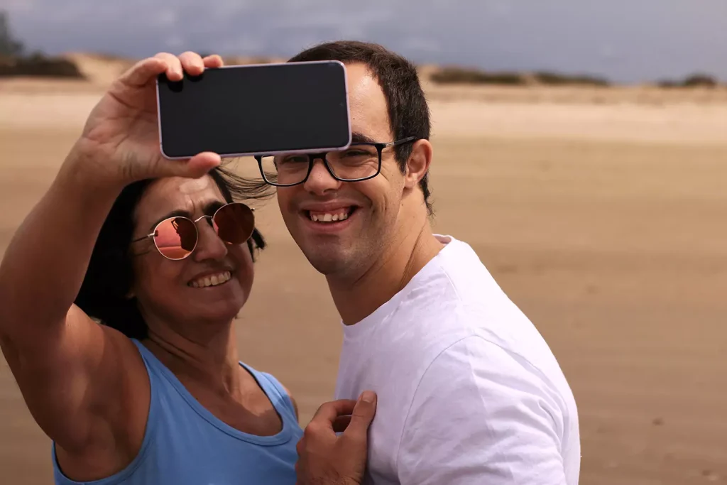 A disabled man and his support worker taking a selfie